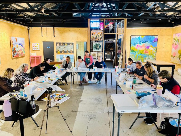 Participants painting at a workshop table